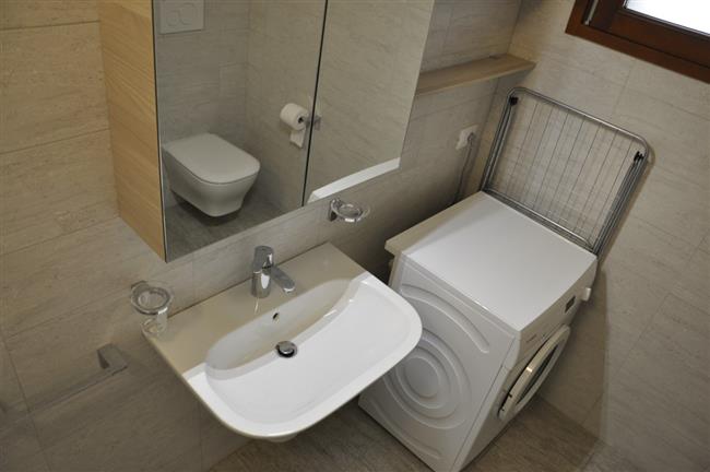 bathroom with shower and washing machine