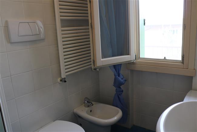 bathroom with shower and washing machine