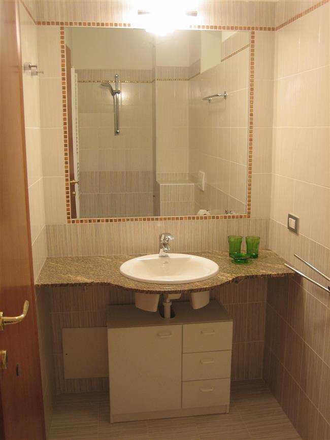 bathroom with shower and washing machine