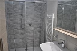 bathroom with shower and washing machine